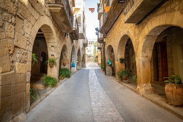 narrow street with traditional old houses in the medieval town of Batea, comarca of Terra Alta,...