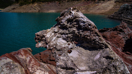 Red stones, blue sky, green water