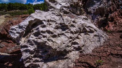 Red stones, blue sky, green water