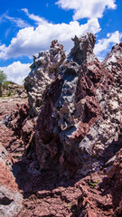 Red stones, blue sky, green water