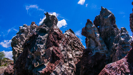 Red stones, blue sky, green water