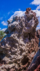 Red stones, blue sky, green water