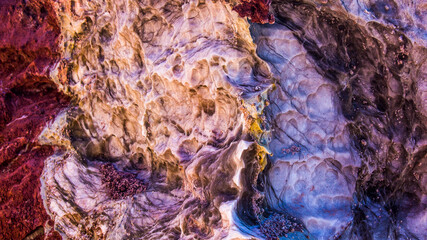 Red stones, blue sky, green water
