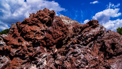 Red stones, blue sky, green water