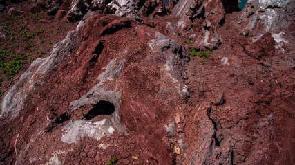 Red stones, blue sky, green water