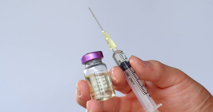 Syringe with needle and medicine bottle.