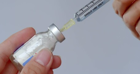 Add water to the powdered medicine mixture in the bottle and shake.Large medicine bottle.Injectable medicine mixed with water before injection. - Powered by Adobe