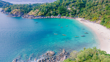 Fototapeta na wymiar Paradise beach Phuket Patong. aerial top view amazing freedom beach small white sand beach with perfect nature. white wave hit the rock around island. green forest peaceful. green sea, landscape.