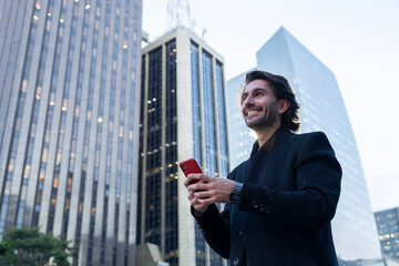 View of young man using a smartphone at twilight