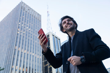 View of young man using a smartphone at twilight