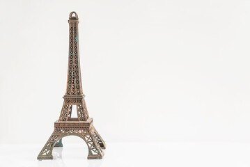 The Eiffel Tower figurine on a white background; copy space