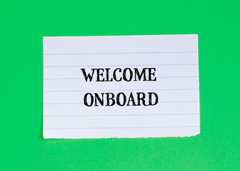 Welcome onboard lettering on ripped paper piece with green background. Conceptual business symbol. Top view, copy space.
