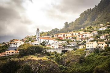 Fototapeta na wymiar miradouro do guindaste, madeira, viewpoint, ocean, cliffs, mountains, waves, portugal, village and church