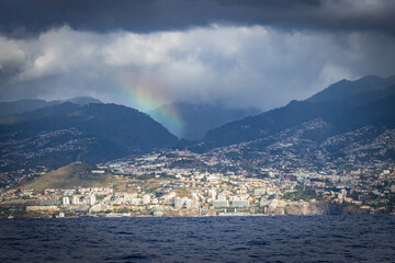 coastline of funchal, madeira, portugal,  panorama, europe, lava formation, cliff, dramatic sky, rainbow