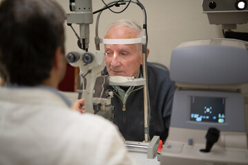 Fototapeta na wymiar An elderly gentleman is seen by an ophthalmologist for retinal thrombosis