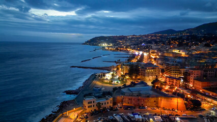 Aerial view of Sanremo at night, Italy. Port and city buildings - 727330048