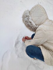 A woman enjoying winter and having fun with snow