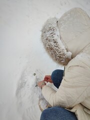 A woman enjoying winter and having fun with snow