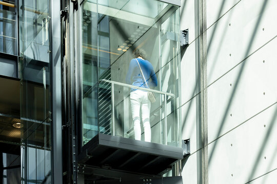 Woman on transparent elevator