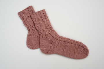 knitted wool socks on a neutral background