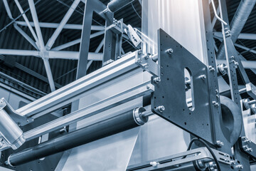 Automatic polyethylene plastic bag production machine with lighting effect. Close-up of the roller...