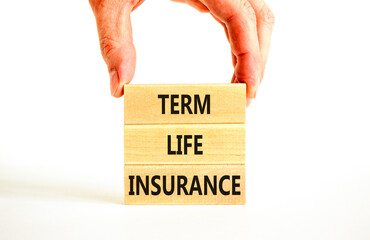 Term life insurance symbol. Concept words Term life insurance on beautiful wooden blocks. Beautiful white table white background. Doctor hand. Medical term life insurance concept. Copy space.