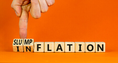 Inflation or slumpflation symbol. Concept word Inflation Slumpflation on beautiful wooden cubes. Beautiful orange background. Businessman hand. Business inflation slumpflation concept. Copy space.
