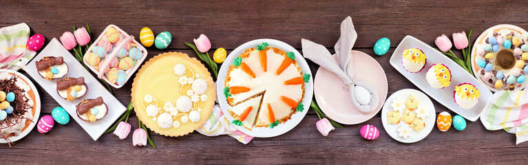 Easter or spring dessert food table scene. Above view over a dark wood banner background. Lemon...