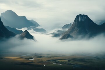 beautiful landscape view of the valley and silhouette mountains in the fog at cold evening