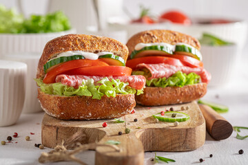 Fresh and healthy sandwich with salami, vegetables and mayonnaise.