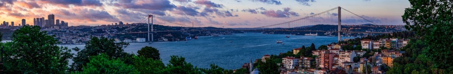 Panoramic view of Istanbul's Bosphorus Bridge at sunset. A breathtaking panoramic view of the Bosphorus Strait in Istanbul, Turkey, featuring the iconic Bosphorus Bridge. Best touristic destination