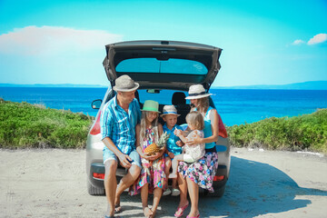 A happy family by car by the sea in nature weekend travel