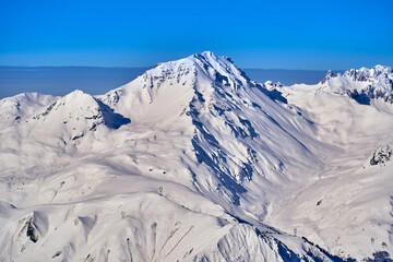 Breathtaking beautiful panoramic view on Snow Alps - snow-capped winter mountain peaks around French Alps mountains, The Three Valleys: Courchevel, Val Thorens, Meribel (Les Trois Vallees), France