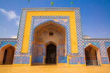 Famous mosque in Thatta, Pakistan. Beautiful architecture, yellow, blue and orange colors. 
