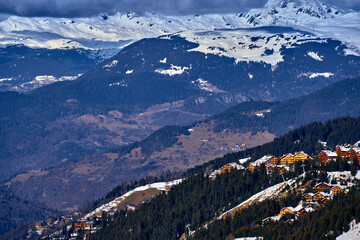 Breathtaking beautiful panoramic view on Snow Alps - snow-capped winter mountain peaks around...