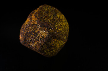 Fototapeta premium Garnet is a precious stone in its natural form on a black background.