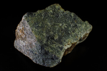 Serpentinite stone mineral on black background.