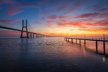 Fototapeta na wymiar Vasco da Gama bridge and pier over tagus river in Lisbon (Portugal),before sunrise