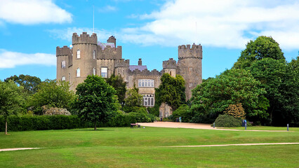 Medieval Malahide Castle with green front garden, Dublin County, Ireland