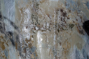 cracked wall with silver paint on it.