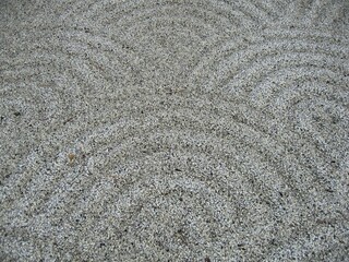 A close up of a pattern of semicircles in a Japanese stonegarden
