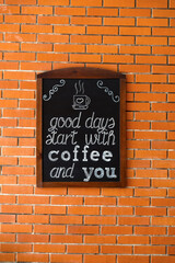 There is a plaque on the brick wall with an inscription in English.
