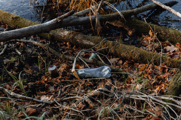 Plastic bottle litter in the forest. Ecological pollution of the surrounding world by human hands