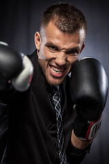 Fototapeta na wymiar Portrait of businessman with boxing gloves
