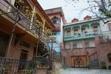 Fototapeta na wymiar Yard with old traditional balconies in downtown in Tbilisi, Georgia.