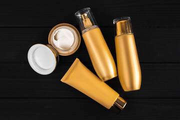Cosmetics in gold tubes. A jar of white cream for body care. Cosmetics mockup