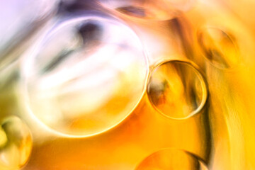Golden yellow and light pink glass orbs, abstract texture background