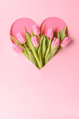 a bouquet of pink tulips in a heart on a pink background, a romantic greeting for the holiday, Mother's Day