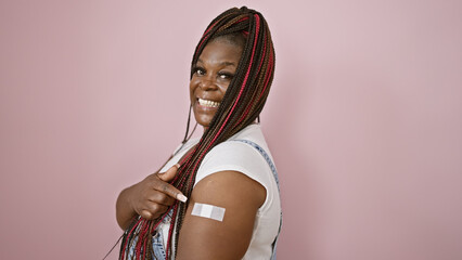 Joyful african american woman, casual fashion queen with braids, pointing finger at vaccination...