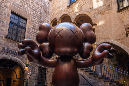 Barcelona, Spain - April 11 2023 : A wooden companion statue by world famous contemporary modern artist KAWS stands in the Moco Museum in the gothic quarter. No people editorial content for articles